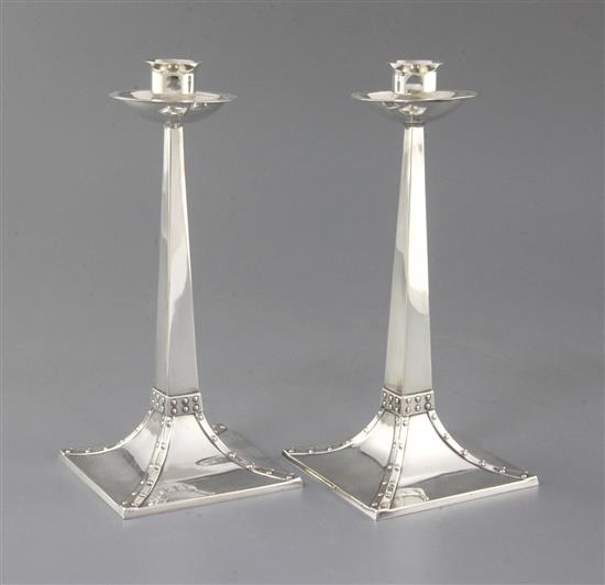 A pair of Edwardian Arts and Crafts silver candlesticks by James Dixon & Sons, 22cm.